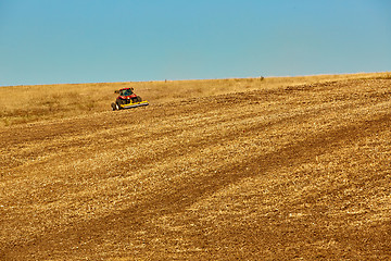 Image showing Agricultural Landscape. Tractor working on the field.