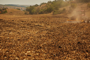 Image showing Agricultural Landscape. Tractor working on the field.