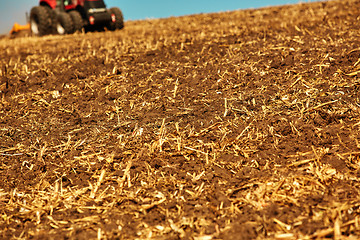 Image showing Agricultural Landscape. Tractor working on the field.