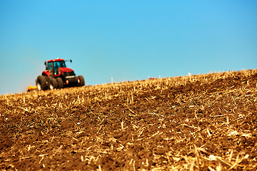 Image showing Agricultural Landscape. Tractor working on the field.