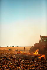 Image showing Agricultural Landscape. Tractor working on the field.