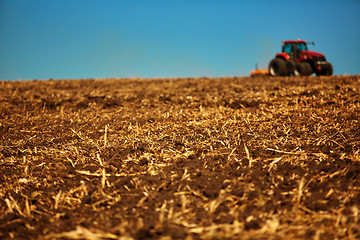 Image showing Agricultural Landscape. Tractor working on the field.