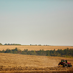 Image showing Agricultural Landscape. Tractor working on the field.