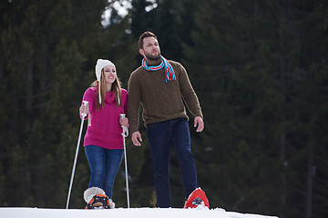 Image showing couple having fun and walking in snow shoes