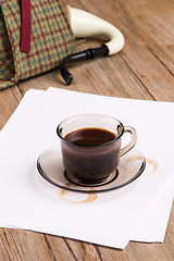 Image showing Coffee cup, paper sheets and detective hat