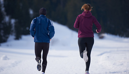 Image showing couple jogging outside on snow