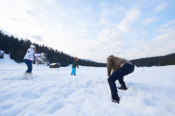 Image showing happy family playing together in snow at winter