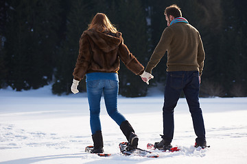 Image showing couple having fun and walking in snow shoes