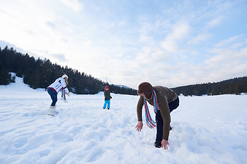 Image showing happy family playing together in snow at winter