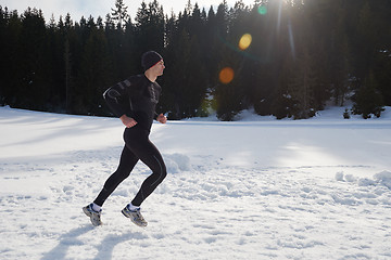 Image showing jogging on snow in forest