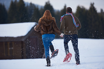 Image showing couple having fun and walking in snow shoes