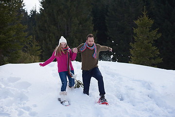 Image showing couple having fun and walking in snow shoes