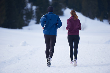 Image showing couple jogging outside on snow