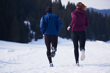 Image showing couple jogging outside on snow