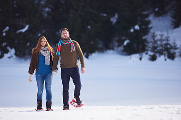 Image showing couple having fun and walking in snow shoes