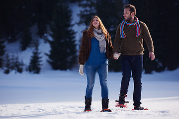 Image showing couple having fun and walking in snow shoes