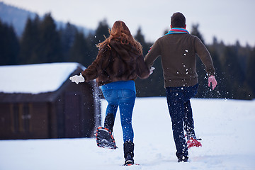 Image showing couple having fun and walking in snow shoes