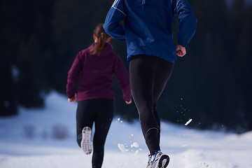 Image showing couple jogging outside on snow