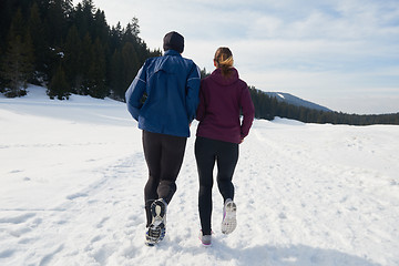 Image showing couple jogging outside on snow