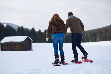 Image showing couple having fun and walking in snow shoes