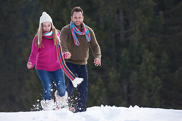 Image showing couple having fun and walking in snow shoes