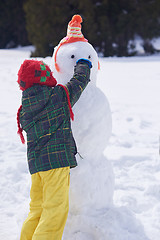 Image showing boy making snowman