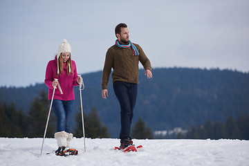 Image showing couple having fun and walking in snow shoes