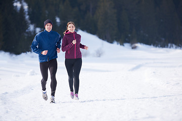 Image showing couple jogging outside on snow