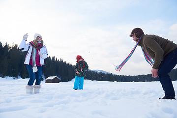 Image showing happy family playing together in snow at winter