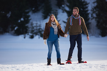 Image showing couple having fun and walking in snow shoes