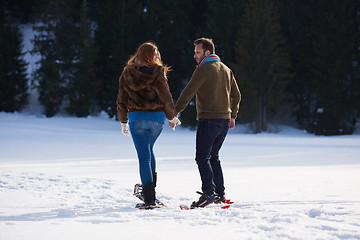 Image showing couple having fun and walking in snow shoes