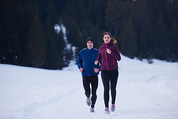 Image showing couple jogging outside on snow