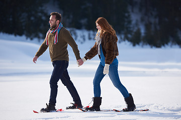 Image showing couple having fun and walking in snow shoes