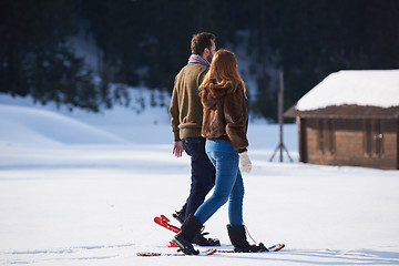 Image showing couple having fun and walking in snow shoes