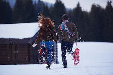 Image showing couple having fun and walking in snow shoes