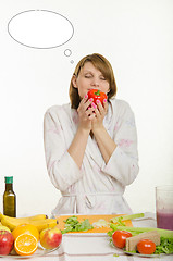 Image showing Young girl smelling a vegetarian peppers with thought cloud over his head