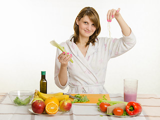 Image showing Happy housewife cleared peel the celery prepare salads