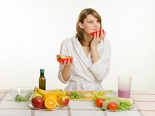 Image showing Young girl with a vegetarian delight sniffing pepper