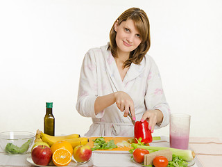 Image showing Young girl with a vegetarian delight cuts pepper