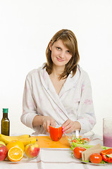 Image showing Young girl cuts pepper vegetarian