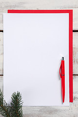 Image showing The blank sheet of paper on the wooden table with a pen 