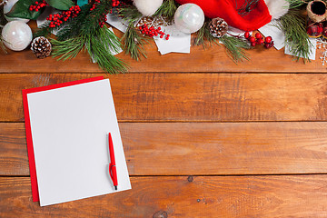 Image showing The blank sheet of paper on the wooden table with a pen 