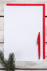 Image showing The blank sheet of paper on the wooden table with a pen 