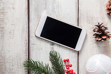 Image showing The wooden table with a phone