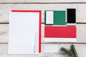 Image showing The blank sheet of paper on the wooden table with a pen 