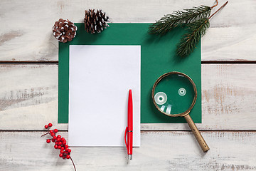 Image showing The blank sheet of paper on the wooden table with a pen 