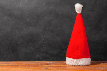 Image showing The Santa red hat on wooden background