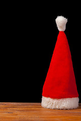 Image showing The Santa red hat on wooden background