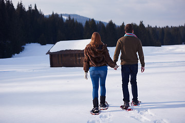 Image showing couple having fun and walking in snow shoes