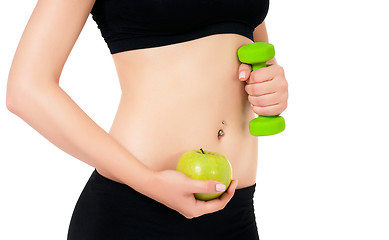Image showing Sporty girl holding weight and apple